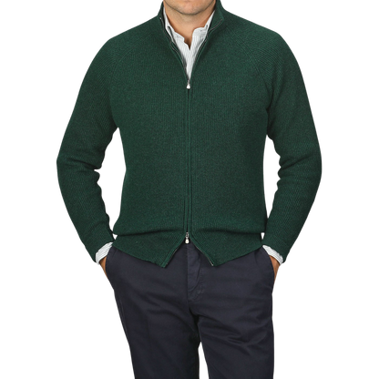 A person wearing a Bottle Green Cashmere Rib Knit Cardigan by Filippo de Laurentiis over a striped shirt with navy pants, standing against a plain background.