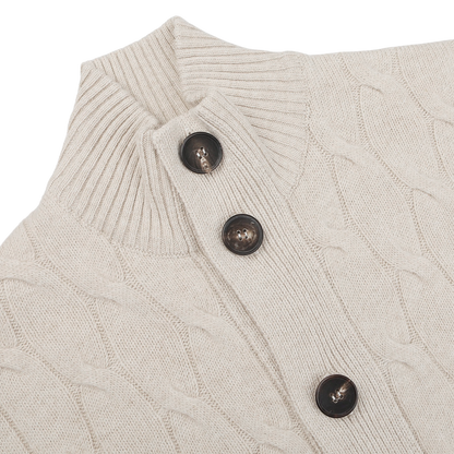 Close-up of the Filippo de Laurentiis Cream Wool Cashmere Cableknit Button Cardigan, showcasing a delicate beige pattern and three dark brown buttons.