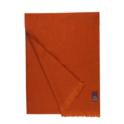 A Burnt Sienna Merino Wool Cashmere Scarf made by Fox Brothers, with fringes on a white background.