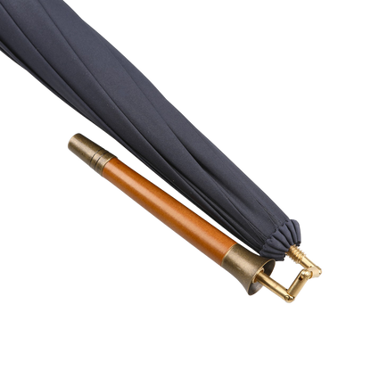 The Fox Umbrellas Navy Blue Malacca Handle Packable Umbrella is handmade in England, featuring a wooden handle with brass accents against a white background.