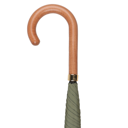Close-up of the Fox Umbrellas Olive Green Polished Maple Handle Umbrella with a neatly folded canopy.