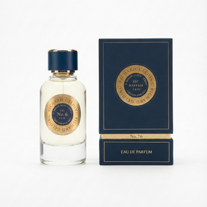 The Richard Gelding No.76 EdP 100ml features a clear glass bottle with a blue and gold cap, paired with a matching box—both showcasing the brand’s refined style and hinting at the sophisticated amber and musk fragrance inside. , available at Richard Gelding Mayfair