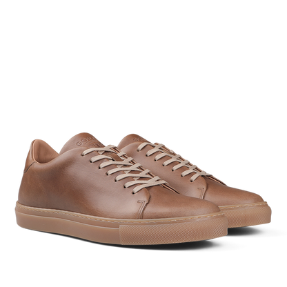 A pair of Goral's Brown Horween Leather Mellor II Sneakers featuring premium-quality leather, white laces, and tan rubber soles.