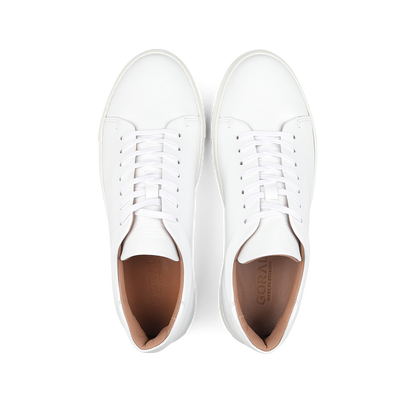 Pair of White Calfskin Mellor II Sneakers with white laces, viewed from above, showcasing the craftsmanship of the esteemed British footwear brand Goral.