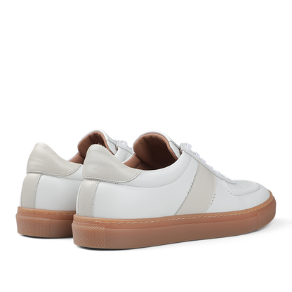 The White Leather Hadfield Sneakers by Goral feature beige accents and light brown rubber soles, viewed from the back and side, evoke the classic style of a German military trainer.