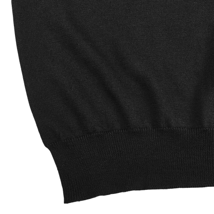Close-up of the lower section of the Gran Sasso Black Extra Fine Merino Wool Rollneck, highlighting the ribbed hem against a plain white background.