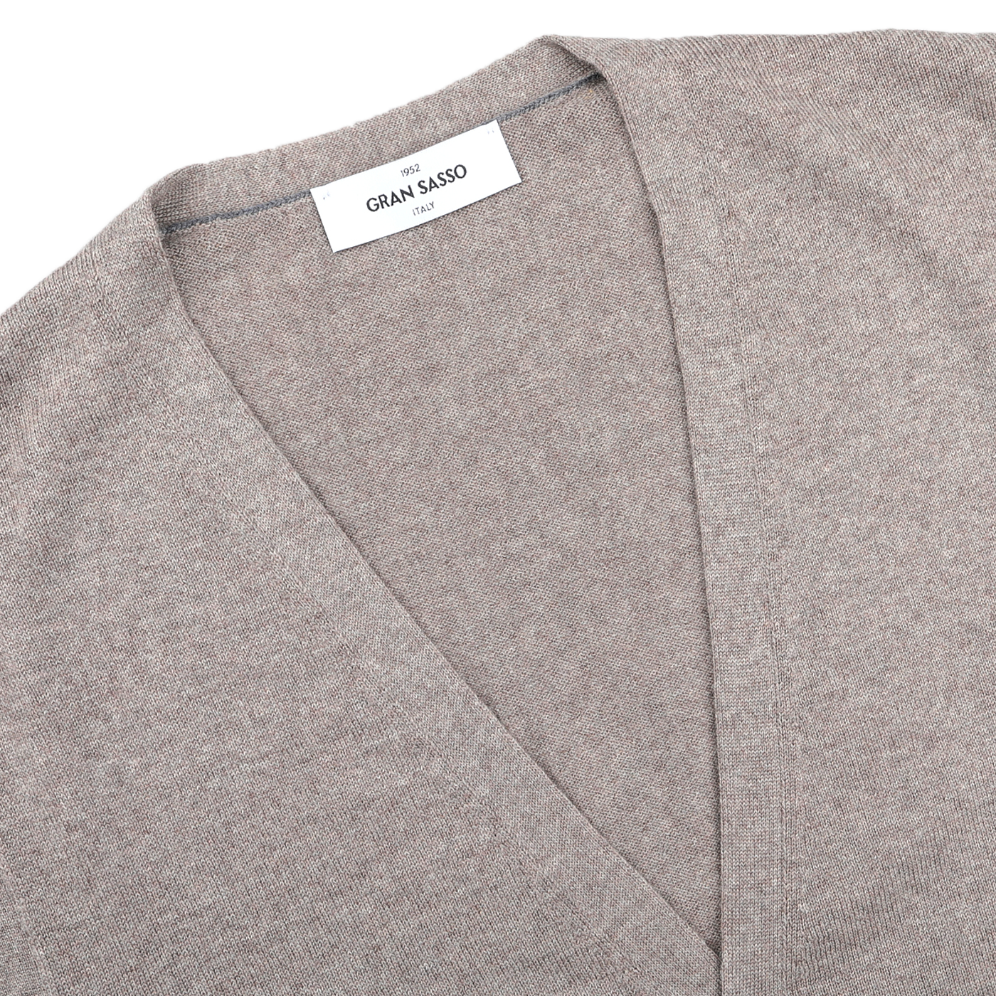 Close-up of a Beige Extra Fine Merino Wool Vest by Gran Sasso, featuring a V-neck collar and visible brand label—perfect for layering.