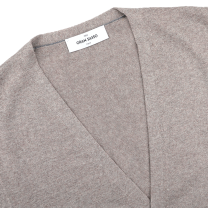 Close-up of a Beige Extra Fine Merino Wool Vest by Gran Sasso, featuring a V-neck collar and visible brand label—perfect for layering.