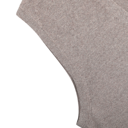 Close-up of Gran Sasso's Beige Extra Fine Merino Wool Vest, showing its light brown heathered knit fabric laid flat on a white surface—perfect for layering.
