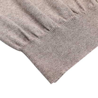 Close-up of the hem and lower sleeve of the Gran Sasso Beige Extra Fine Merino Wool Vest on a white background, ideal for layering with your favorite sleeveless cardigan.