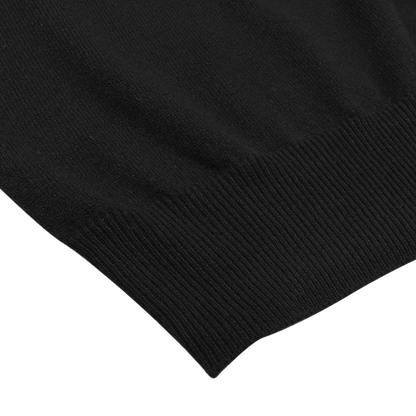 Detailed view of the hem of a Gran Sasso Black Cashmere Crewneck Sweater, crafted entirely from pure cashmere, set against a white background.