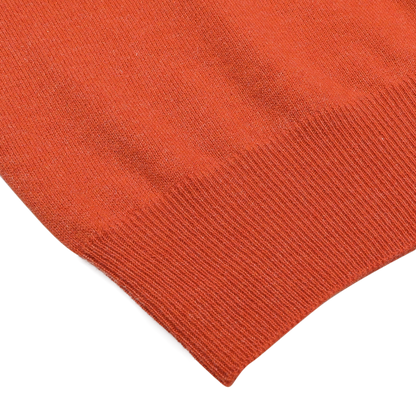 Close-up of the Bright Orange Cashmere 1/4 Zip Sweater by Gran Sasso on a plain background, highlighting the textured fabric and ribbed hem, exemplifying premium knitwear.