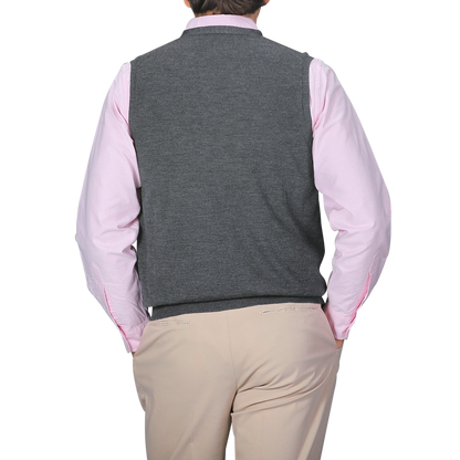 A person is shown from the back wearing a light pink shirt, beige pants, and the Gran Sasso Charcoal Extra Fine Merino Wool Vest against a plain gray background.