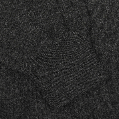 Featured is a close-up of the elegant Charcoal Grey Cashmere V-Neck Sweater by Gran Sasso, highlighting its sustainable knitwear with exquisite ribbed textures.