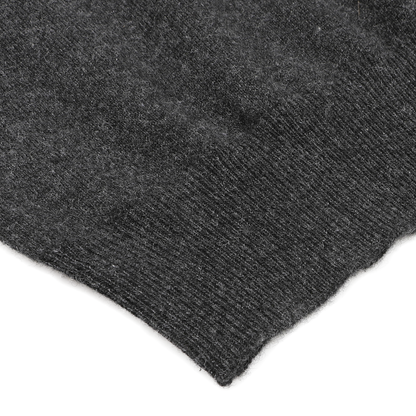 Close-up of the Charcoal Grey Cashmere V-Neck Sweater by Gran Sasso, highlighting the luxurious ribbed texture of its woolen fabric against a light background. This elegant knit detail showcases the exceptional craftsmanship and sustainable quality found in pure cashmere fibers.