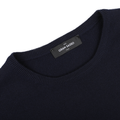 Close-up of the Dark Navy Cashmere Crewneck Sweater, featuring the 'Gran Sasso' label on the inside collar.