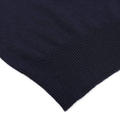 A close-up of the ribbed edge on the Dark Navy Cashmere Crewneck Sweater by Gran Sasso showcases sustainable knitwear at its finest.