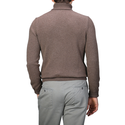 A person wearing a Fawn Brown Air Wool Rollneck by Gran Sasso and gray pants is shown from the back.