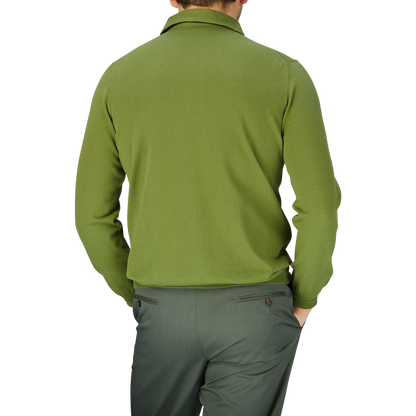 Rear view of a man wearing a Gran Sasso Green Organic Cotton LS Polo Shirt and matching trousers, standing against a light blue background.