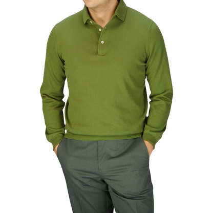Man in a Gran Sasso Green Organic Cotton LS Polo Shirt and gray trousers against a light gray background.
