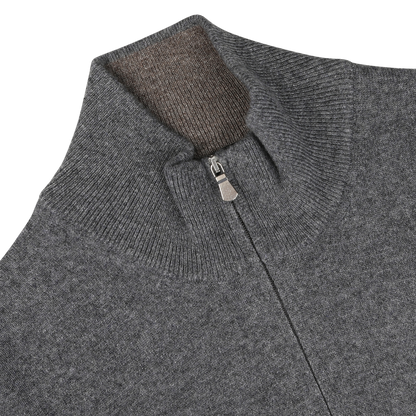 Close-up of the Gran Sasso Grey Melange Cashmere 1/4 Zip Sweater, showcasing its high collar with a partially open zipper that reveals the inner collar lining. Meticulously crafted from pure cashmere, the fabric exudes a soft and textured feel, epitomizing luxurious premium knitwear.