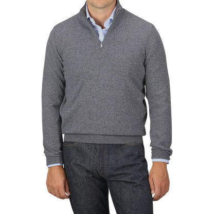 A person wearing a Gran Sasso Grey Melange Cashmere 1/4 Zip Sweater over a light blue shirt and dark jeans. Their head is not visible in the image.