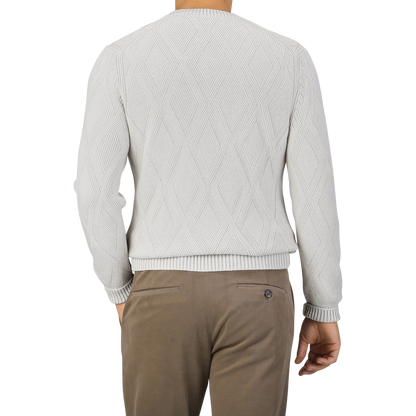 A person wearing a Gran Sasso Light Grey Wool Cashmere Diamond Knit Sweater and brown pants is shown from the back.