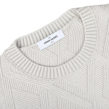 Close-up of the Gran Sasso Light Grey Wool Cashmere Diamond Knit Sweater, highlighting its durable and comfortable textured diamond knit pattern and featuring a white label at the neckline.