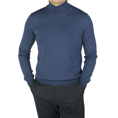A man wearing a Gran Sasso Mid Blue Extra Fine Merino Roll Neck sweater.