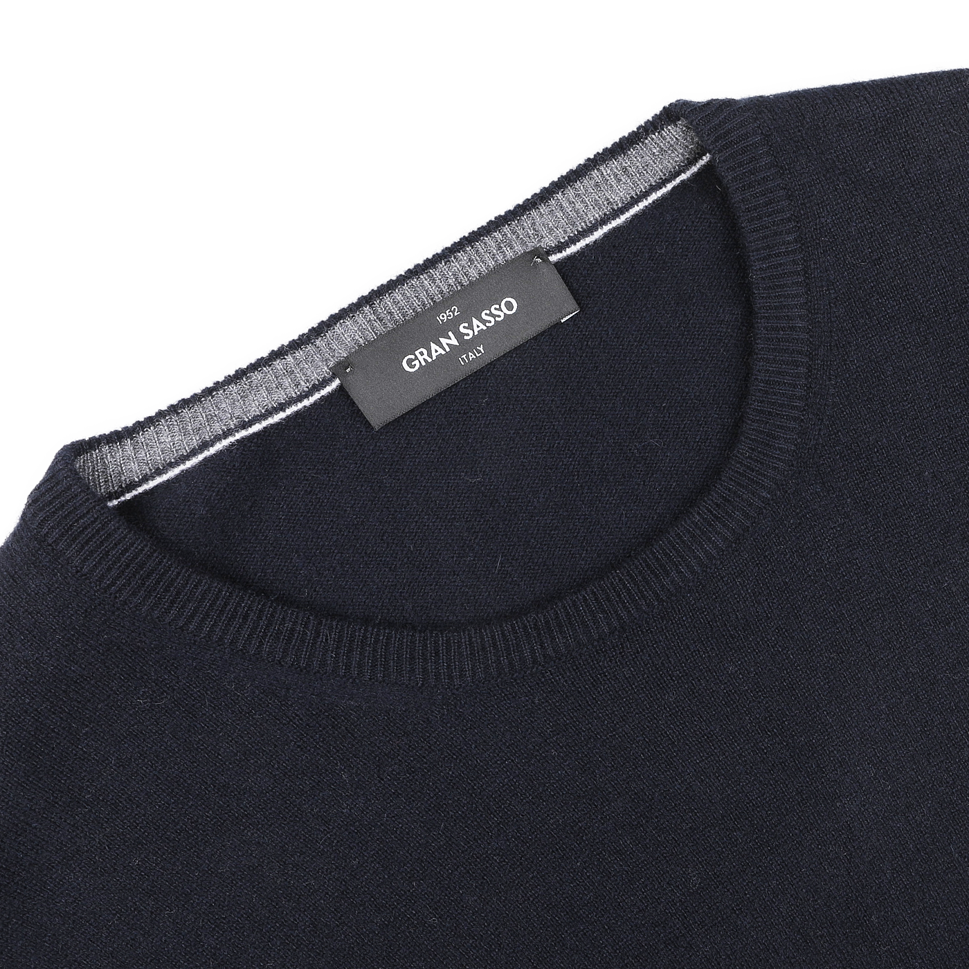 Close-up of the Navy Blue Cashmere Crew Neck Sweater by Gran Sasso, crafted from premium cashmere fibers with a label stating "Gran Sasso" and "Made in Italy.