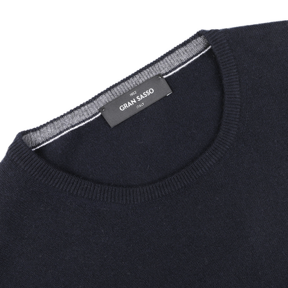 Close-up of the Navy Blue Cashmere Crew Neck Sweater by Gran Sasso, crafted from premium cashmere fibers with a label stating "Gran Sasso" and "Made in Italy.
