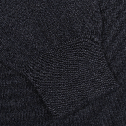 Close-up of a navy blue Gran Sasso crew neck sweater sleeve, highlighting the ribbed cuff and luxurious softness of cashmere fibers.