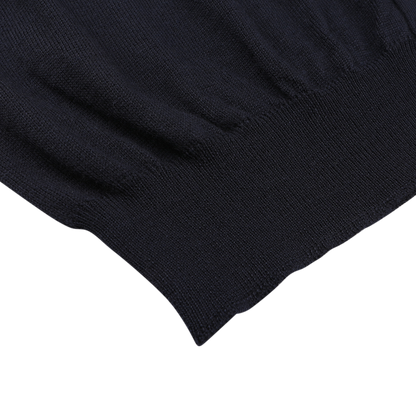 Close-up of Gran Sasso’s navy blue extra fine merino wool vest, highlighting the ribbed hem and soft texture—ideal for layering under any sleeveless cardigan.