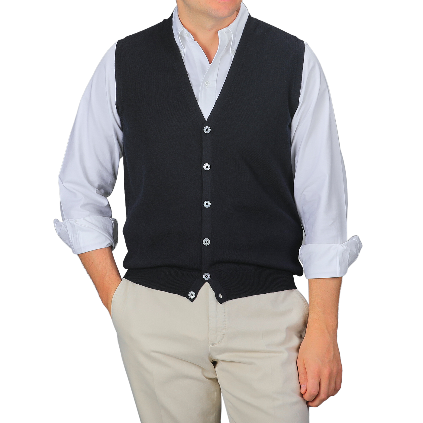 A person wearing a white dress shirt, beige pants, and a Gran Sasso Navy Blue Extra Fine Merino Wool Vest stands against a plain gray background.