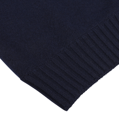 Close-up of the edge of a Navy Blue Felted Cashmere Zip Cardigan by Gran Sasso, featuring ribbed detailing at the hem, crafted from luxurious cashmere.