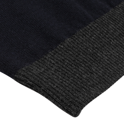 Close-up of a navy blue wool cashmere zip cardigan with a ribbed texture and contrasting gray knit edge, highlighting the exquisite craftsmanship of premium knitwear from Gran Sasso.