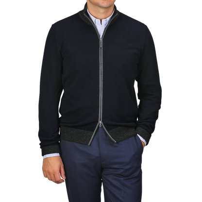 A person stands casually with one hand in their pocket, wearing Gran Sasso's Navy Blue Wool Cashmere Zip Cardigan over a striped shirt and navy pants.