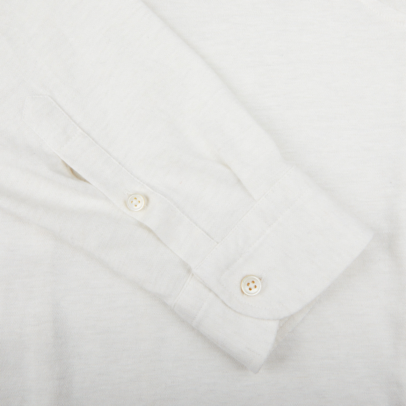 A close up of a Gran Sasso Off-White Cotton Cashmere Knitted Shirt with buttons.
