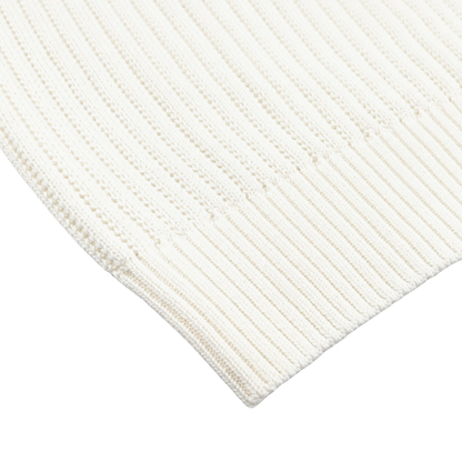 Close-up of an Off-White Organic Cotton Polo Shirt by Gran Sasso, featuring a ribbed knit texture and a visible hemline.