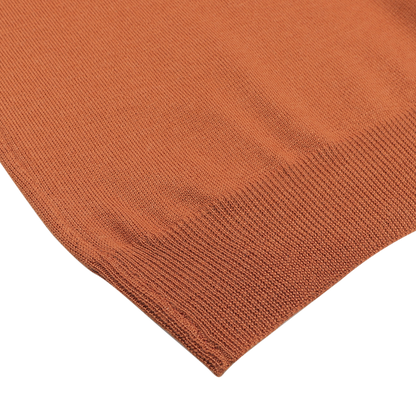 Close-up of a Sienna Brown Extrafine Merino Wool Zip Cardigan by Gran Sasso, showcasing its texture and edge details against a neutral background.