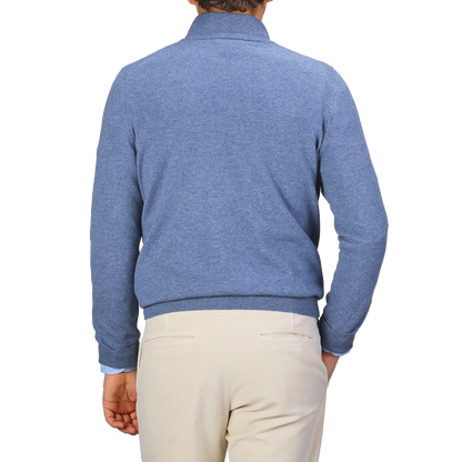 A person wearing a Gran Sasso Sky Blue Cashmere 1/4 Zip Sweater and beige pants stands facing away.