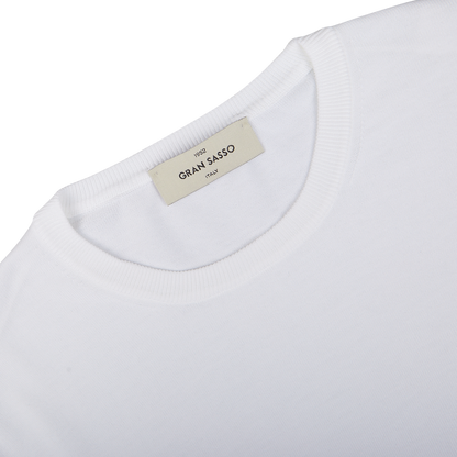 Close-up view of a white knitted Gran Sasso Organic Cotton T-shirt's collar with a "Gran Sasso" size label.