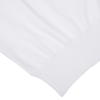 Close-up view of a Gran Sasso white organic cotton t-shirt texture with detailed stitching, focused on the hem.