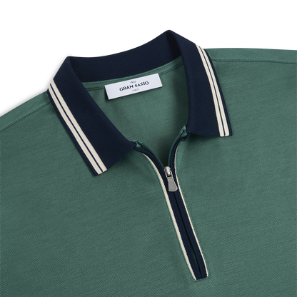 A close-up of the Gran Sasso Green Cotton Filo Scozia Zip Polo Shirt, featuring a navy zip-up collar with white double stripes, a silver zipper with navy trim, and the Gran Sasso label sewn inside the collar. , available at Richard Gelding Mayfair
