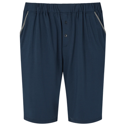 The Homebody Navy Modal Jersey Pyjama Shorts feature an elastic waistband, two side pockets with light gray trim, a two-button fly, and are crafted from soft Modal Sens fabric for luxe bedtime comfort and a simple, casual look. , available at Richard Gelding Mayfair