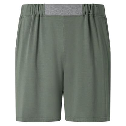The Homebody Charred Green Modal Wimbledon Shorts feature an elastic waistband, grey back panel, and two side pockets. Made from breathable fabric for a relaxed fit, they're perfect for casual or athletic wear with no visible logos or patterns. , available at Richard Gelding Mayfair