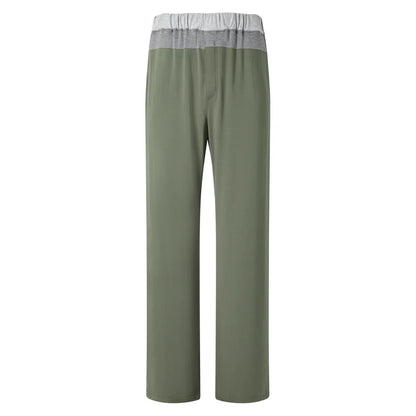 The Homebody Charred Green Modal Duo Trousers are straight-leg lounge pants in olive green with a wide color-blocked waistband, made from breathable Modal Sens fabric, relaxed fit, and no visible pockets or drawstring, shown on a white background. , available at Richard Gelding Mayfair