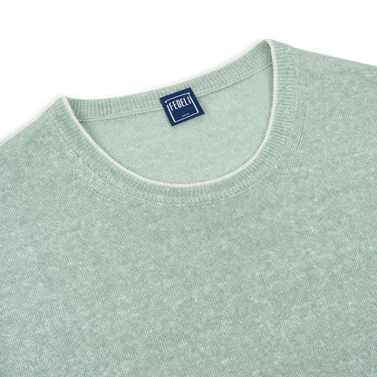 A close-up of a Green Melange Linen Cotton T-Shirt by Fedeli, featuring a soft textured knit and crew neckline with subtle white inner trim. A blue woven label with white "Fedeli 1923" text is sewn inside the center collar. , available at Richard Gelding Mayfair