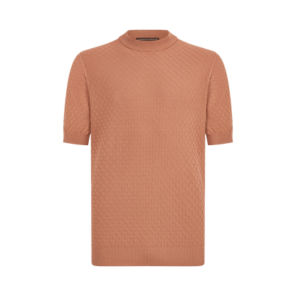 The Filippo de Laurentiis Peach 3D Weave Crepe Cotton T-Shirt features short sleeves, a mock turtleneck, ribbed cuffs and hem, and a subtle geometric pattern. Displayed on a plain white background. , available at Richard Gelding Mayfair