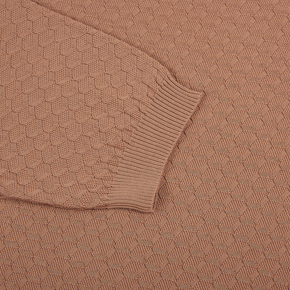 A close-up of the Filippo de Laurentiis Peach 3D Weave Crepe Cotton T-Shirt highlights its textured geometric hexagon pattern and ribbed cuff, showcasing the thick, cozy fabric in a soft dusty peach shade. , available at Richard Gelding Mayfair